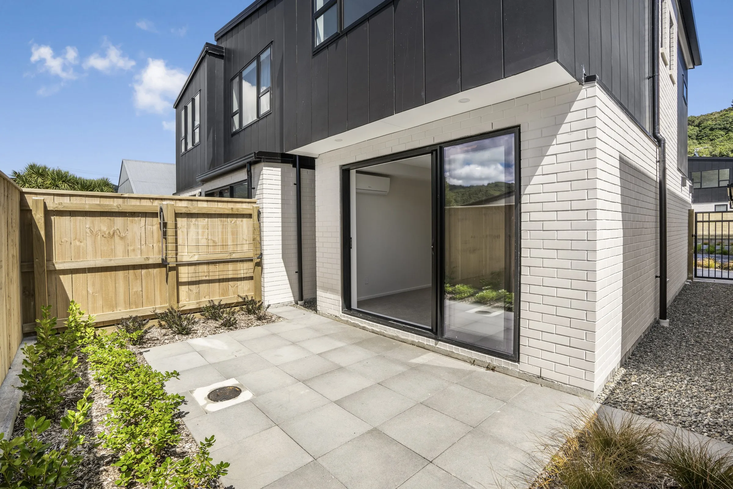 Paved courtyard behind a townhouse