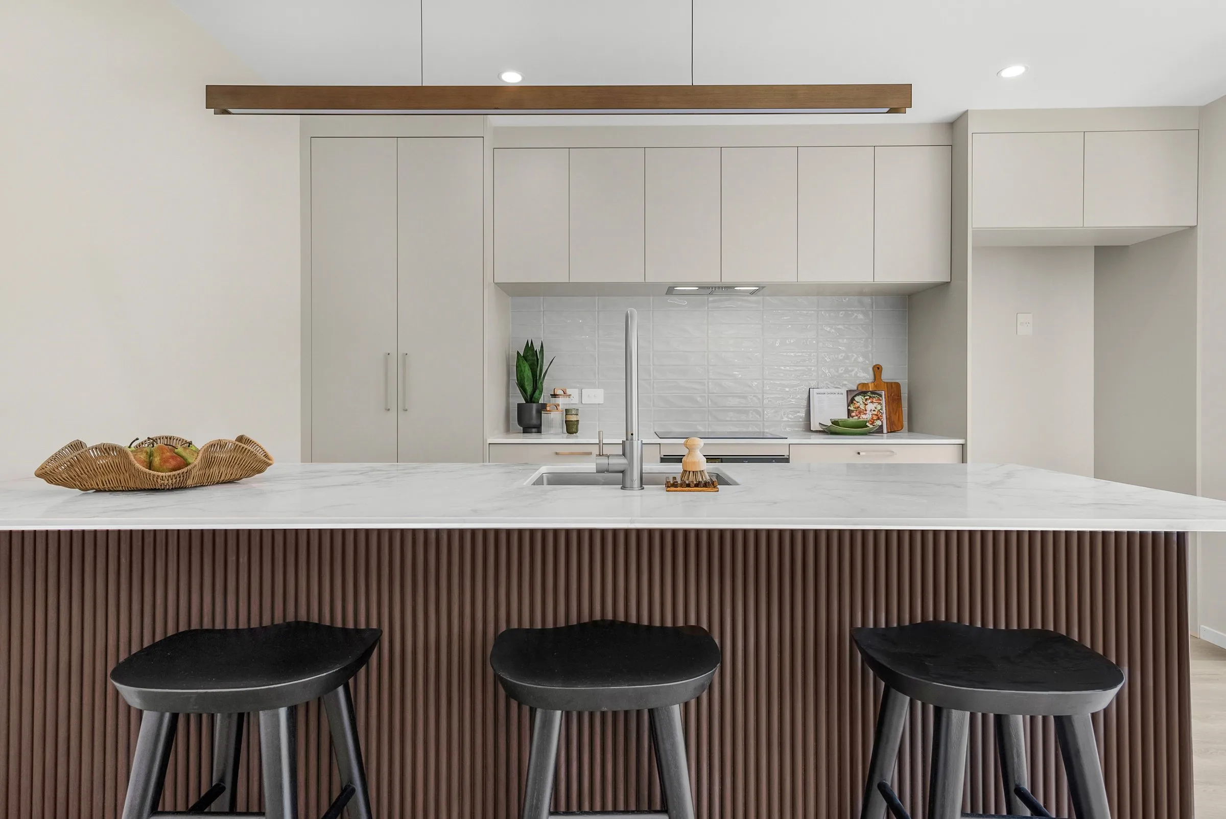 Kitchen with a generous island and dark timber detailing