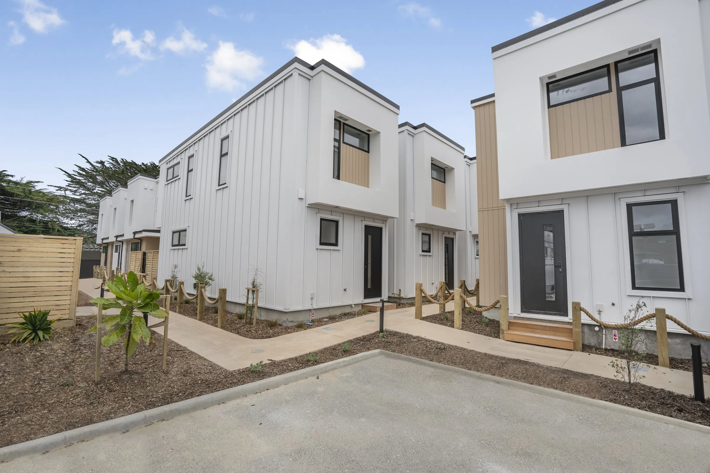 Townhouses with coastal style landscaping